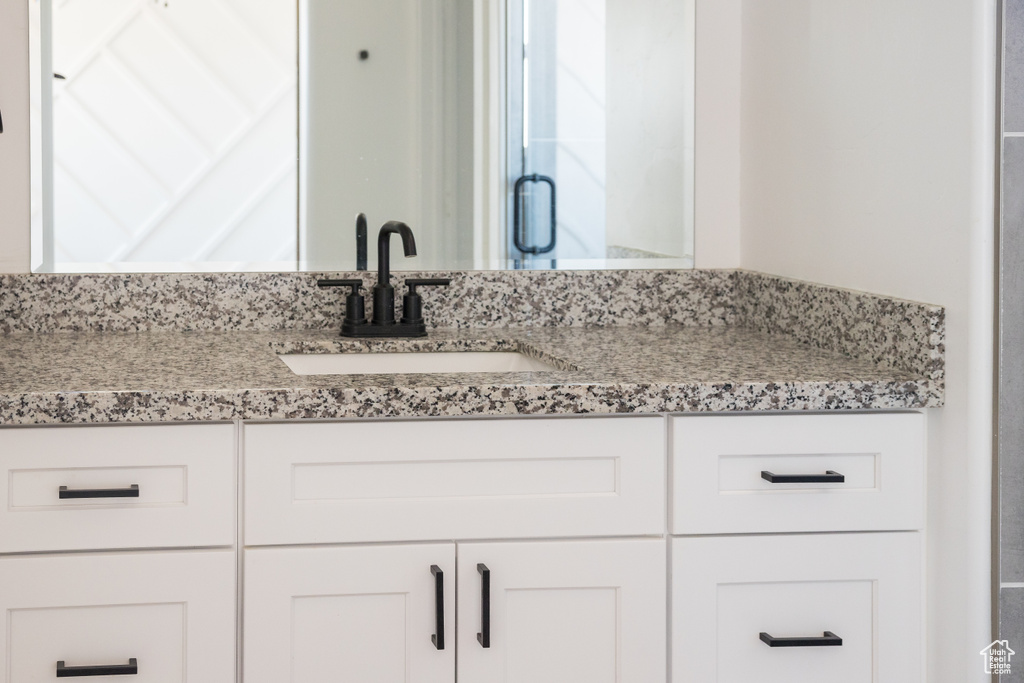 Bathroom featuring vanity and a shower stall