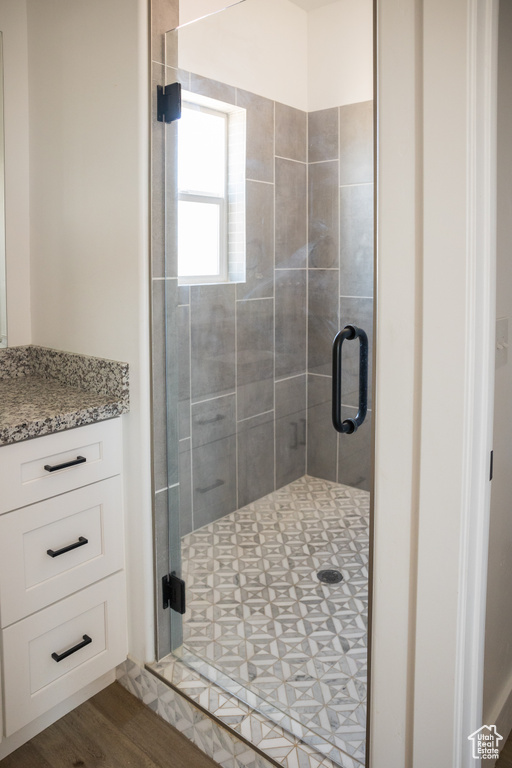 Bathroom with a shower stall and vanity