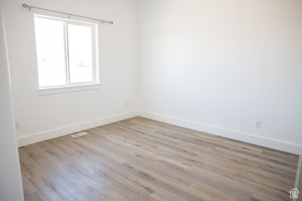 Spare room with wood finished floors and baseboards