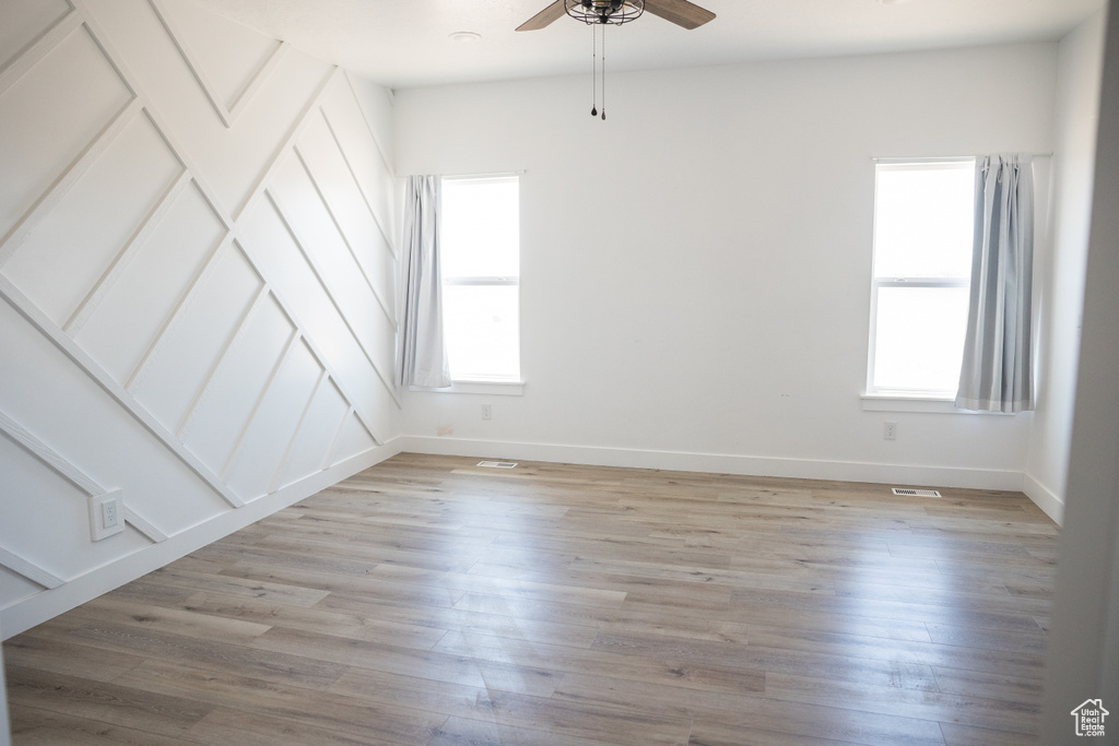 Spare room featuring ceiling fan and light wood finished floors