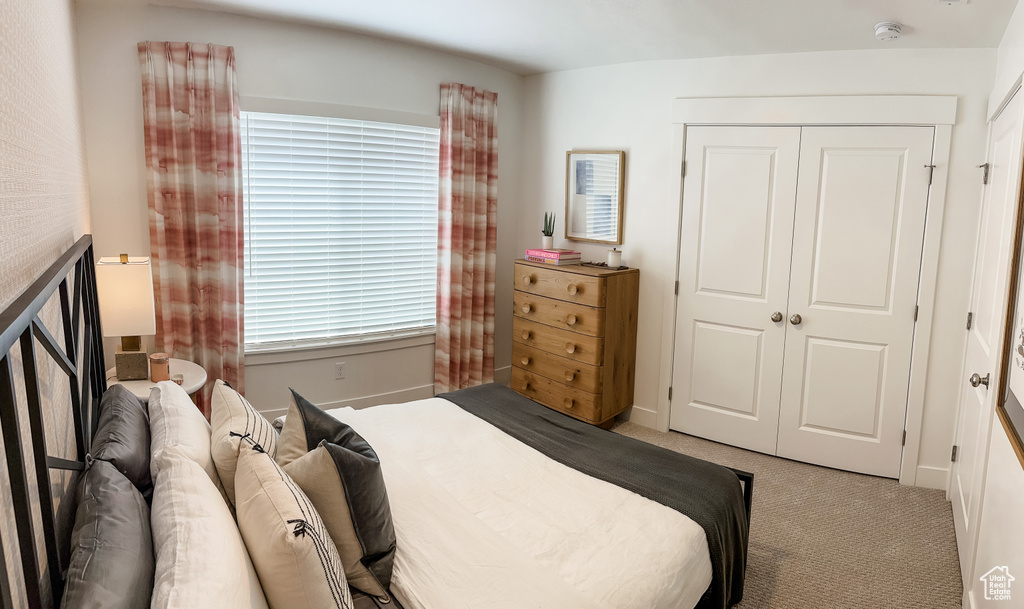 Carpeted bedroom with a closet