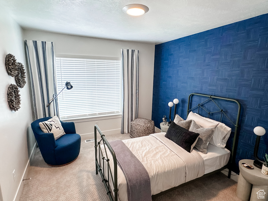 Bedroom with carpet and a textured ceiling