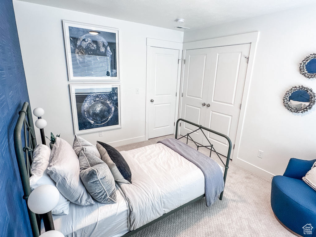Bedroom featuring a closet and light colored carpet