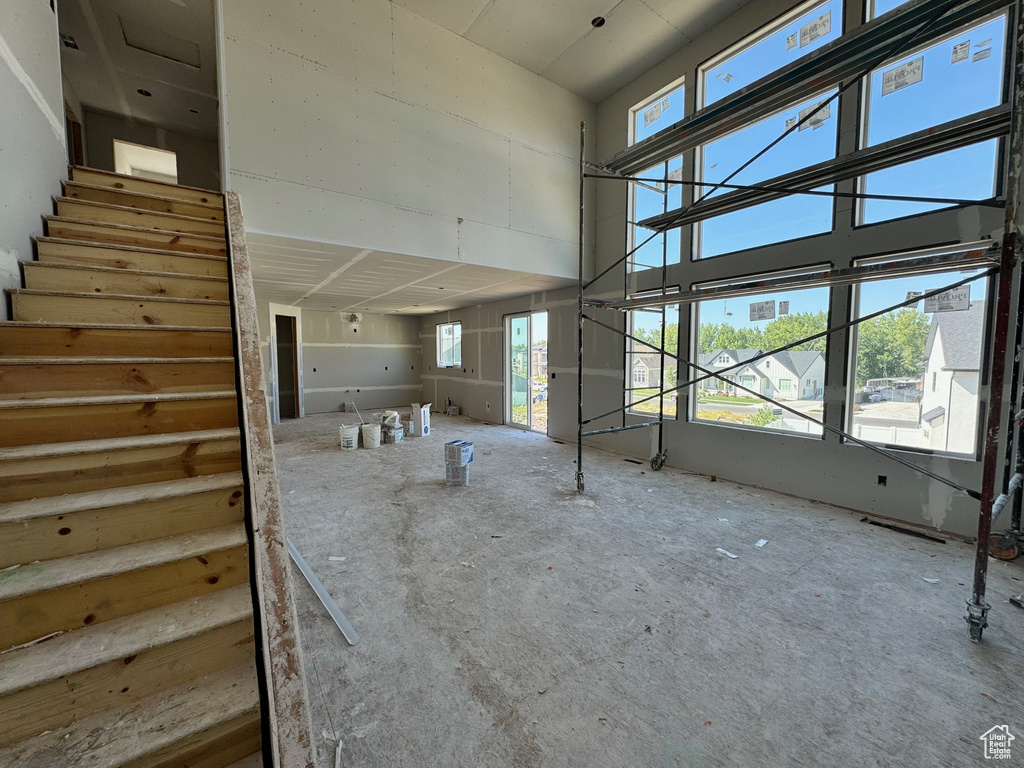 Stairs featuring a towering ceiling