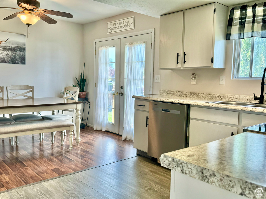Kitchen featuring dishwasher, light hardwood / wood-style floors, and plenty of natural light
