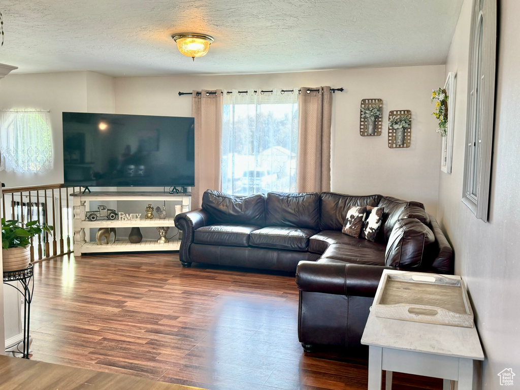 Living room with hardwood / wood-style flooring and a textured ceiling