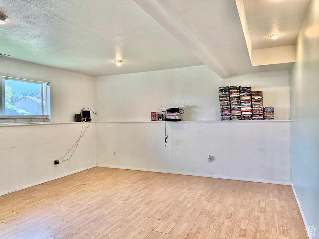 Empty room featuring light hardwood / wood-style flooring and a textured ceiling