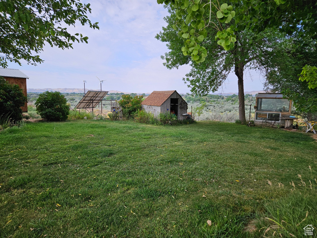 View of yard with an outbuilding and a rural view