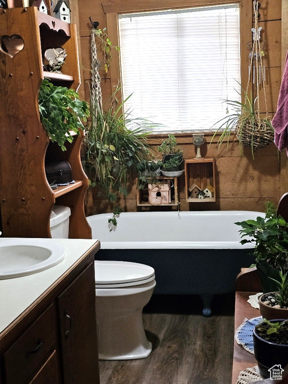 Bathroom featuring hardwood / wood-style flooring, vanity, plenty of natural light, and toilet