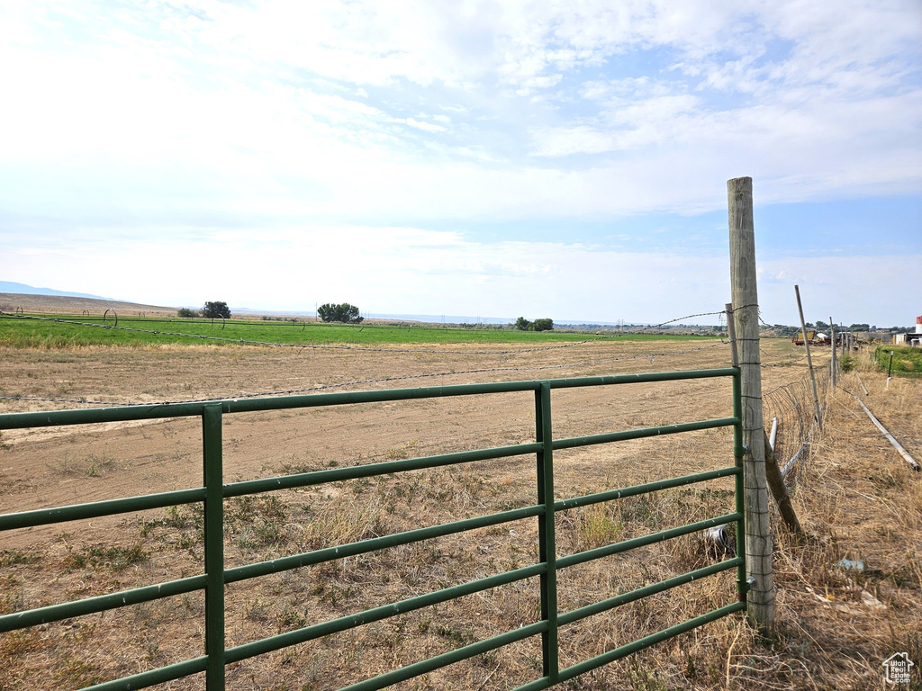 View of gate with a rural view