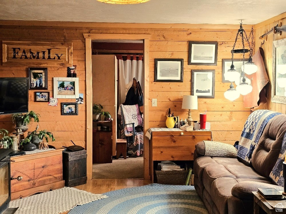 Living room featuring wooden walls and hardwood / wood-style floors