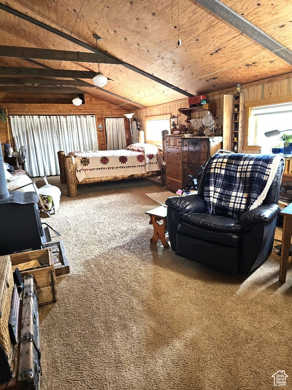 Living room featuring wooden ceiling, wood walls, lofted ceiling, and carpet floors