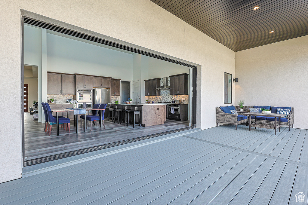 Wooden deck featuring outdoor lounge area