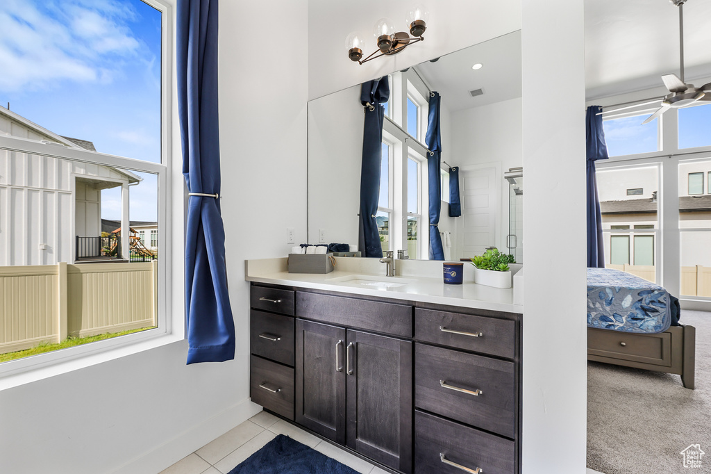 Bathroom with vanity, ceiling fan, and tile patterned floors