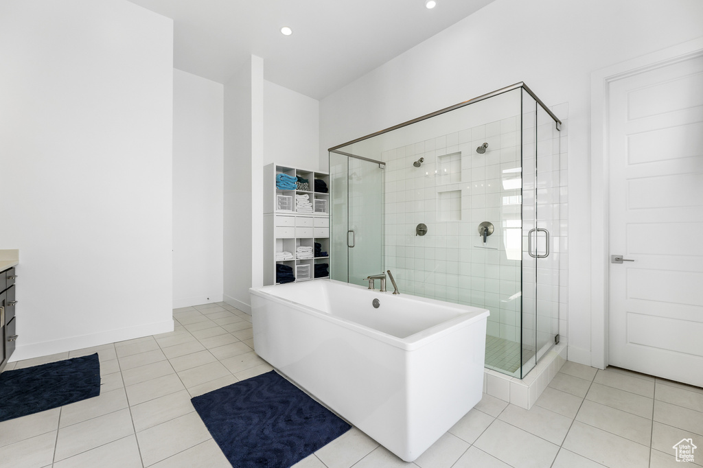 Bathroom featuring tile patterned floors, plus walk in shower, and vanity