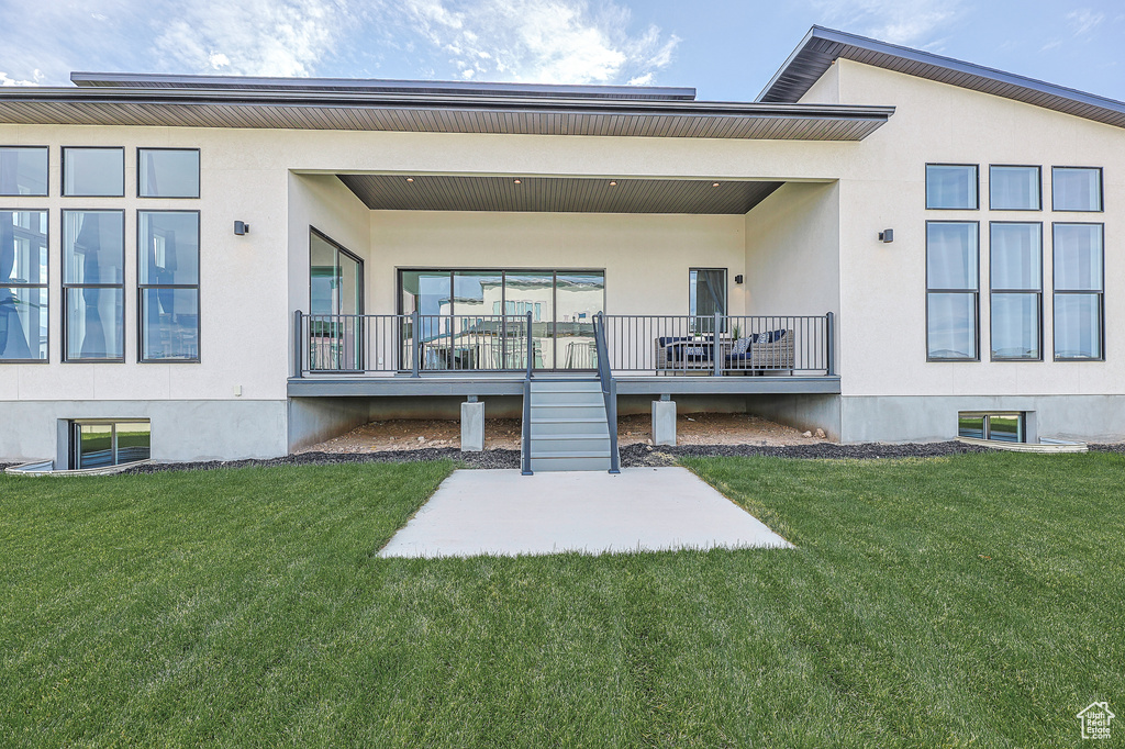 Rear view of property featuring a lawn