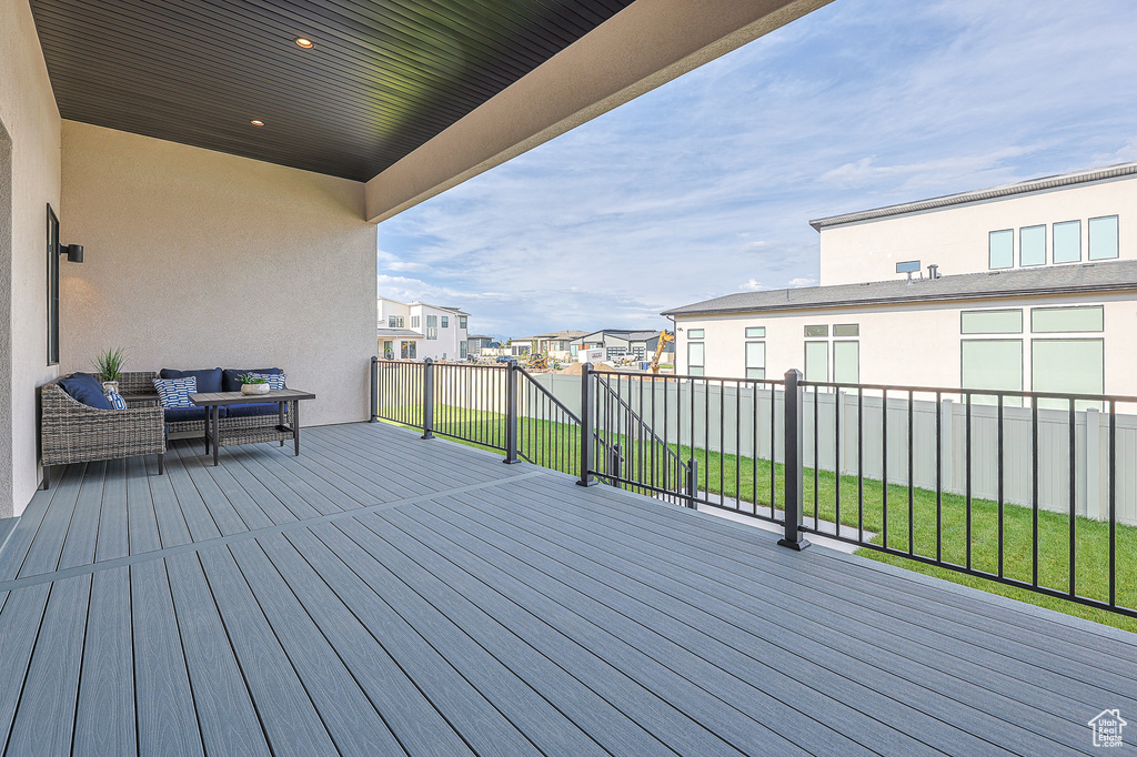 Wooden terrace featuring a yard