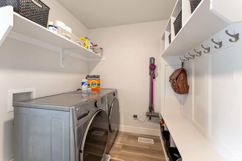 Laundry room featuring light hardwood / wood-style flooring and washer and dryer