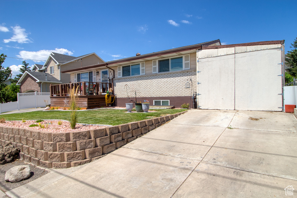 Back of property with a deck and a yard