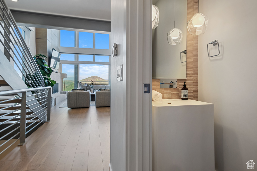 Bathroom featuring wood-type flooring and a high ceiling