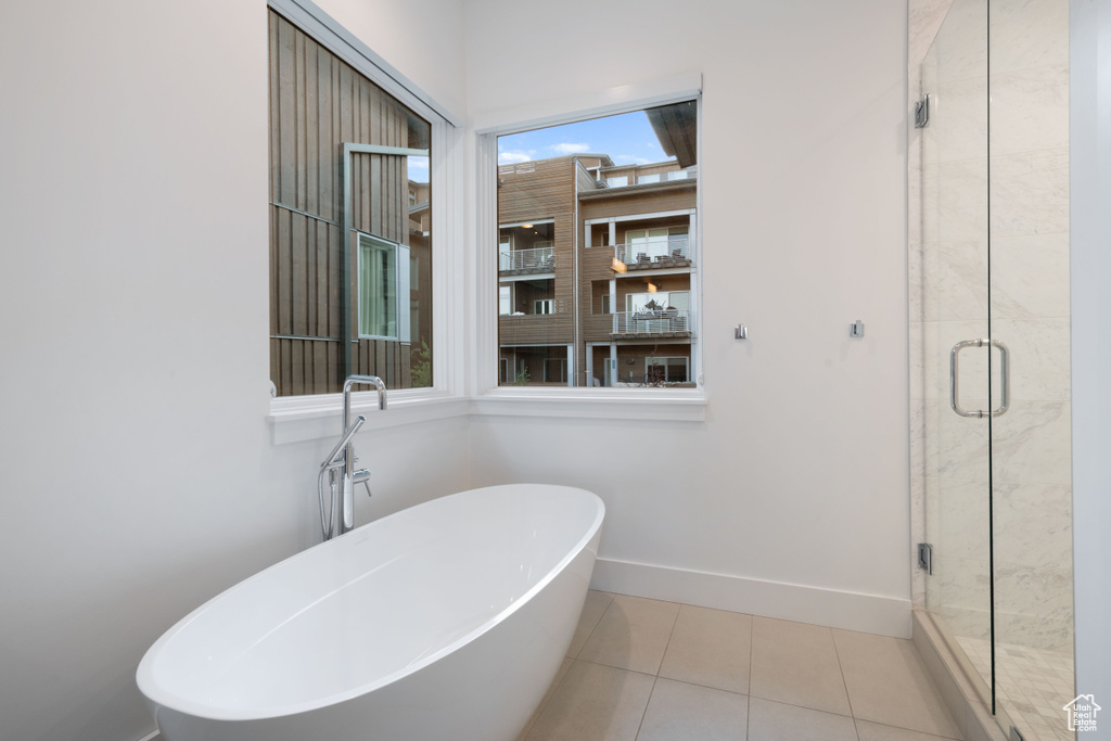 Bathroom with independent shower and bath and tile patterned floors