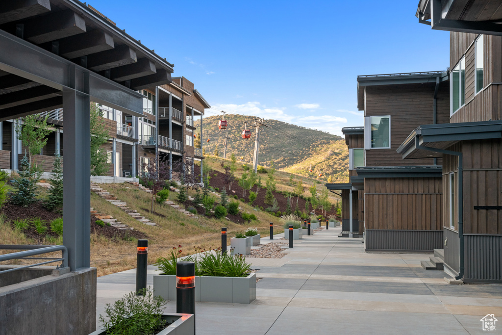 View of property\'s community featuring a mountain view and a patio area