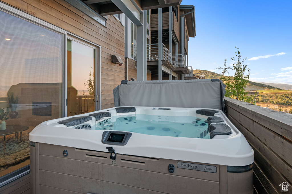 Exterior space featuring a balcony and a hot tub