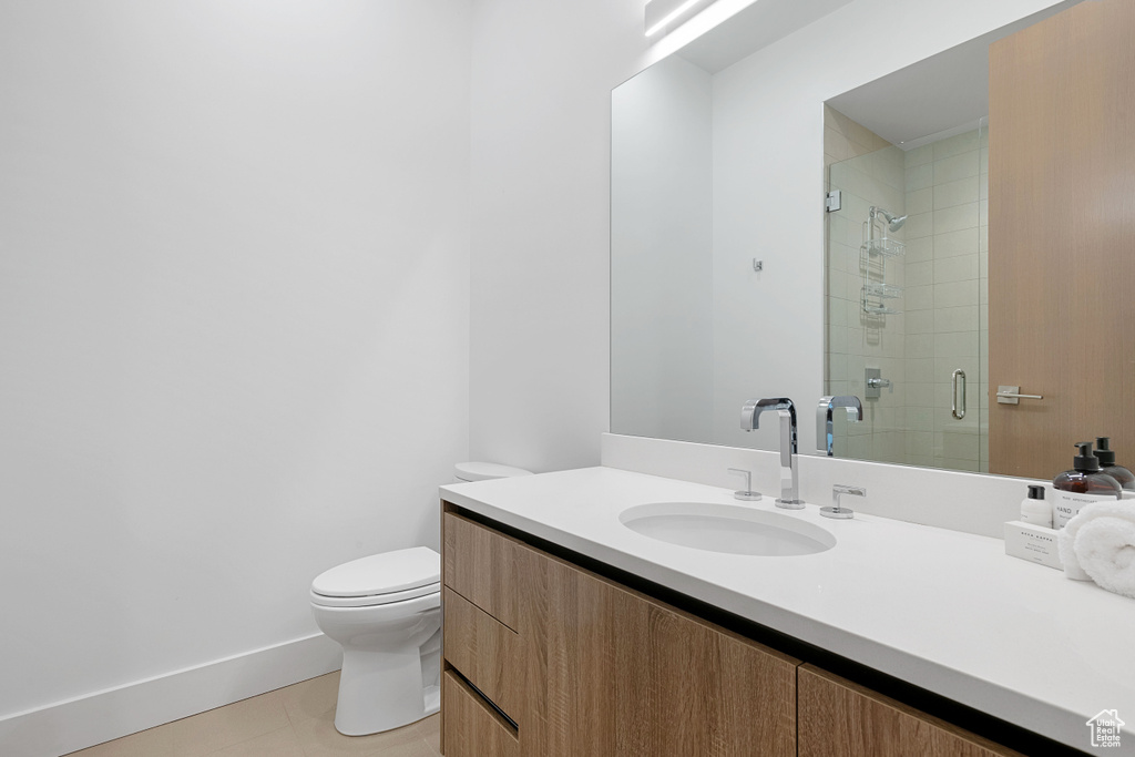 Bathroom with tile patterned flooring, toilet, and vanity