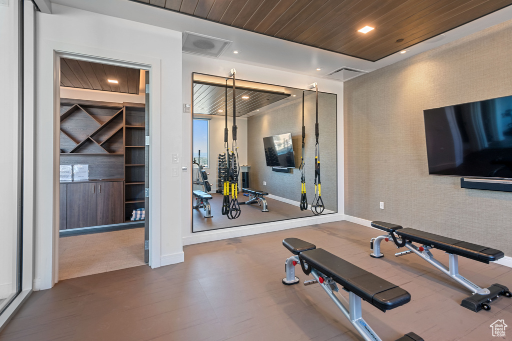 Workout room featuring hardwood / wood-style floors and wooden ceiling