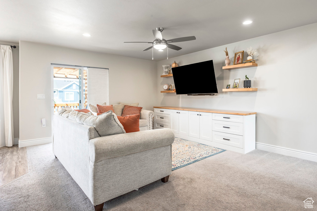 Living room featuring light colored carpet and ceiling fan