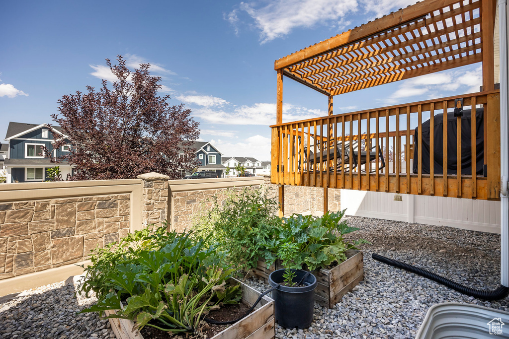 View of yard with a pergola and a wooden deck