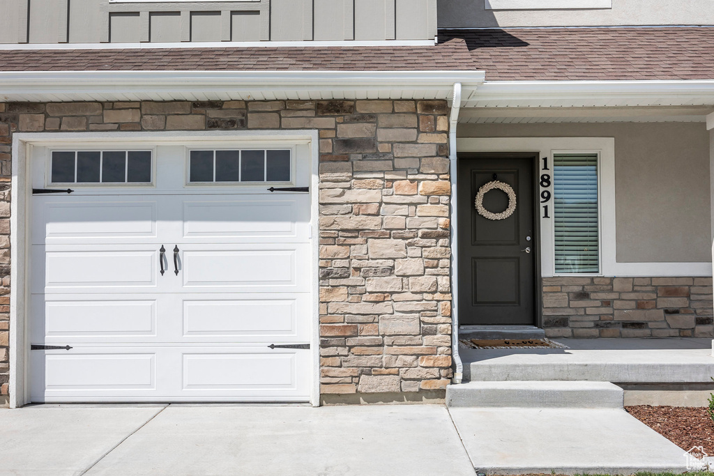 View of exterior entry featuring a garage