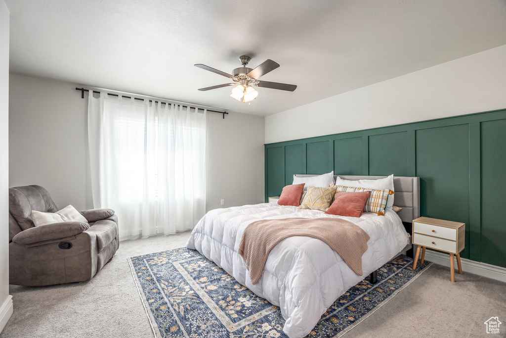 Carpeted bedroom with ceiling fan