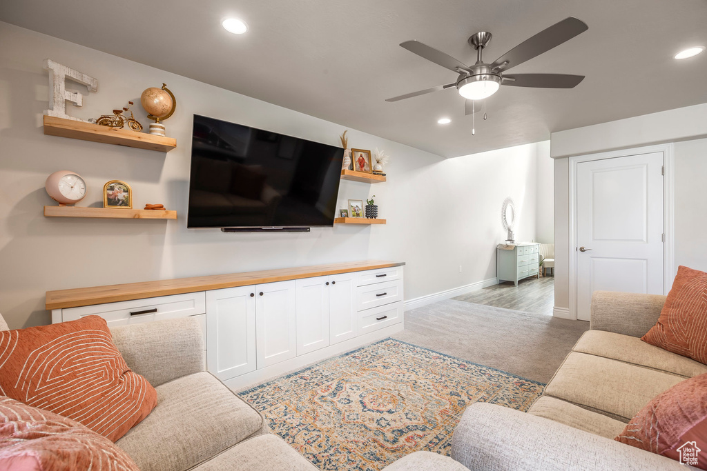 Living room featuring light colored carpet and ceiling fan