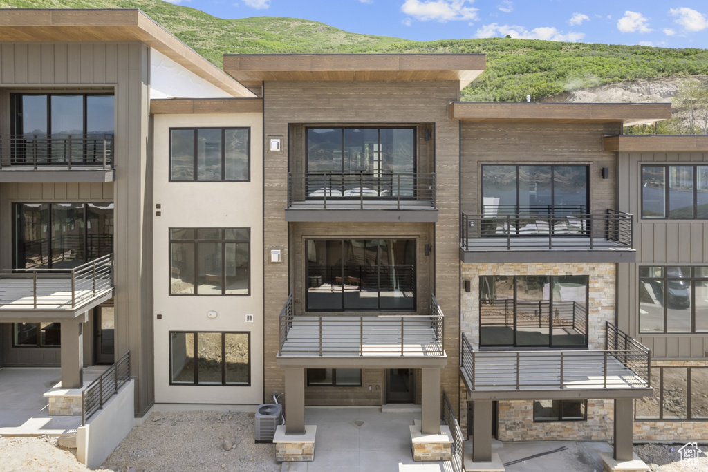 View of property featuring a mountain view and central air condition unit