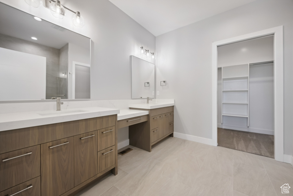 Bathroom featuring double vanity and tile patterned flooring