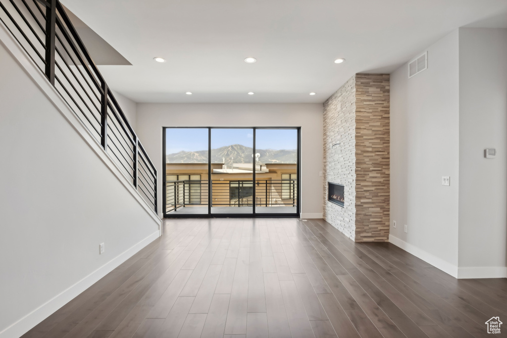 Unfurnished living room featuring a fireplace and wood-type flooring