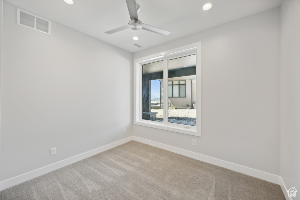 Unfurnished room with carpet floors and ceiling fan