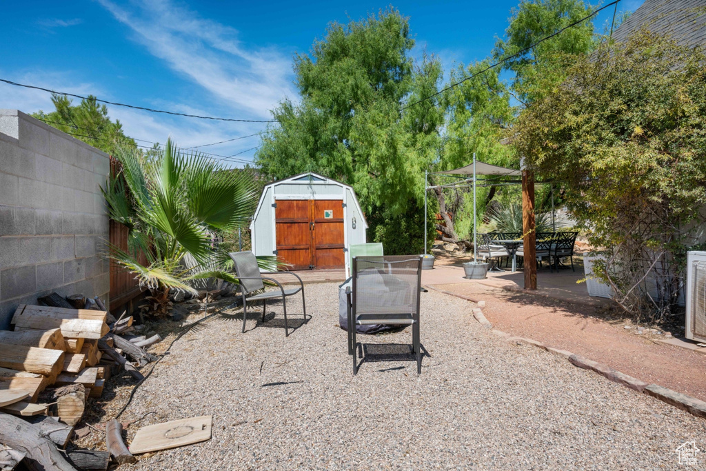 View of patio / terrace featuring a storage unit