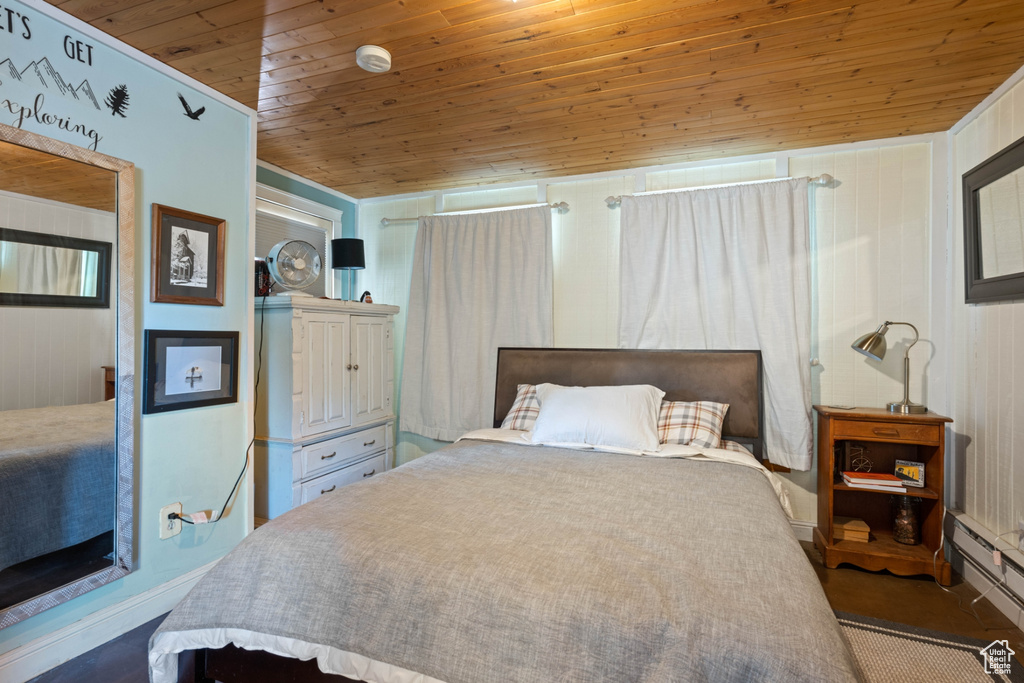 Bedroom featuring wood ceiling and a baseboard radiator