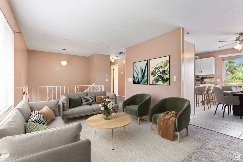 Living room featuring ceiling fan and light tile patterned floors