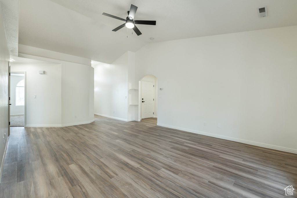 Unfurnished room featuring ceiling fan, hardwood / wood-style flooring, and high vaulted ceiling