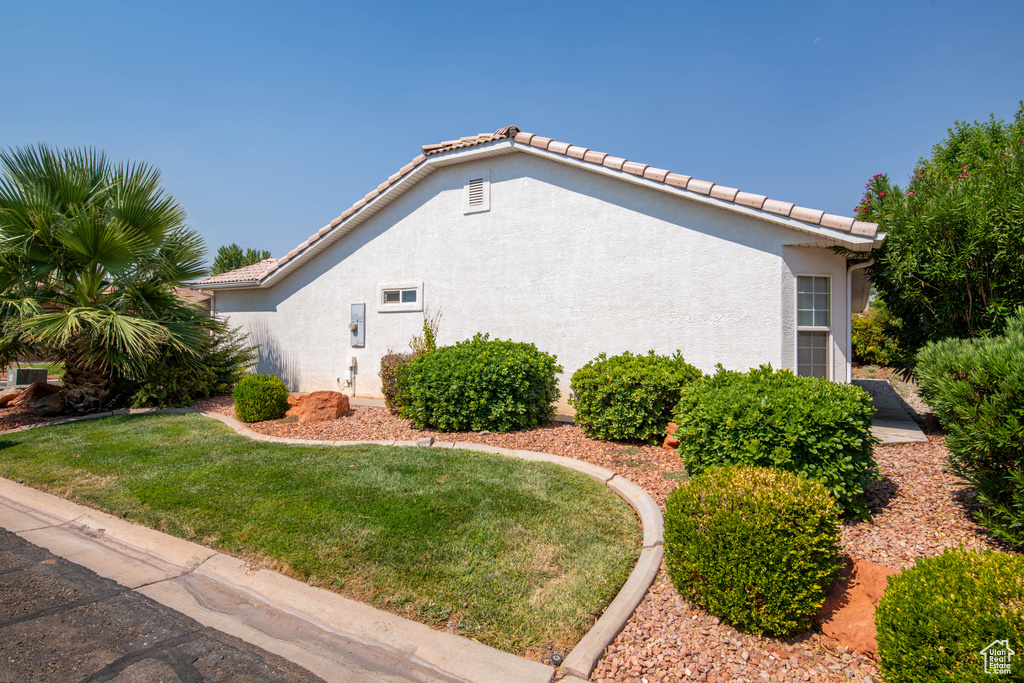 View of home's exterior with a yard