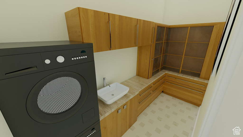 Bathroom with tile patterned flooring, washer / clothes dryer, and sink