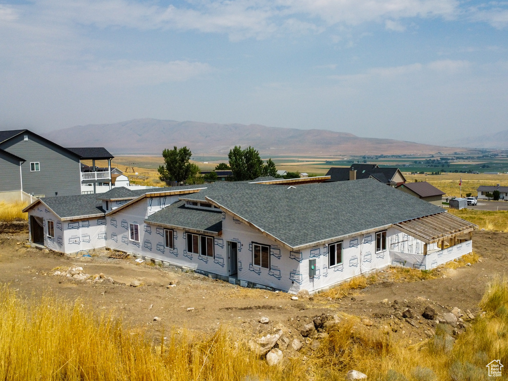 View of property exterior featuring a garage and a mountain view