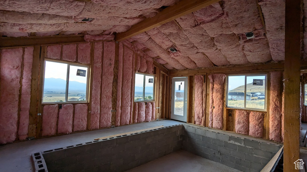 Unfurnished sunroom with a mountain view and vaulted ceiling