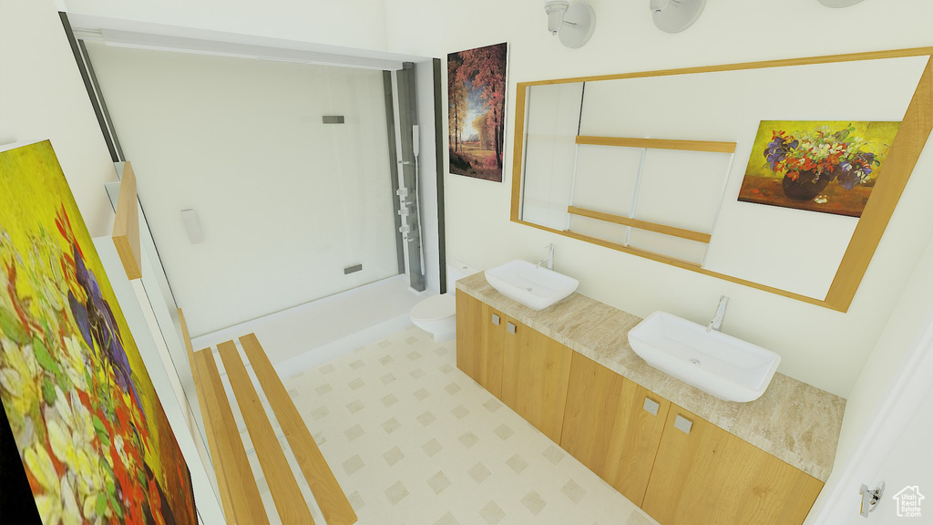 Bathroom featuring vanity, tile patterned flooring, and toilet