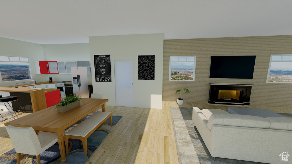 Dining area featuring brick wall, a multi sided fireplace, and light wood-type flooring