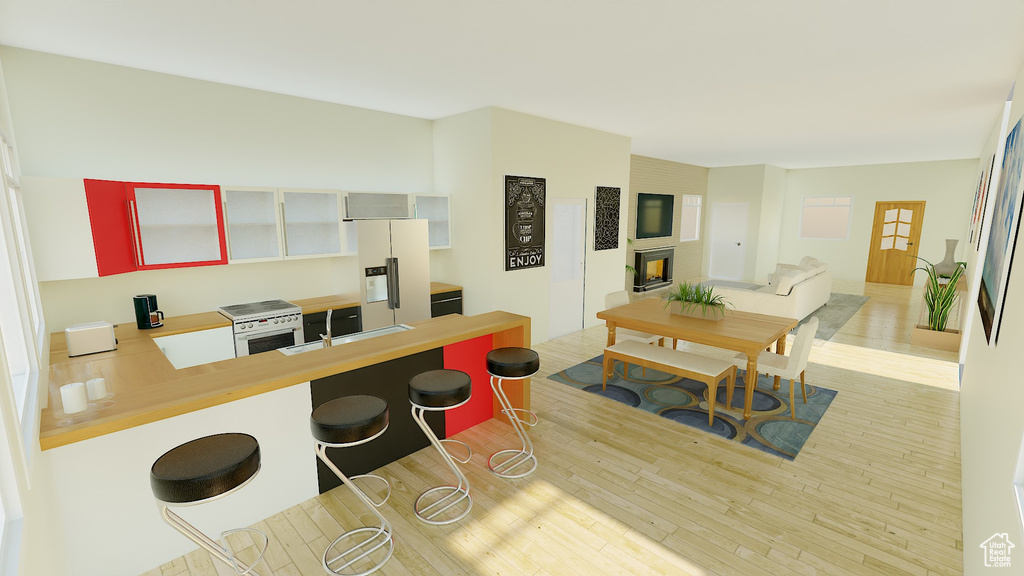 Kitchen with a breakfast bar, light hardwood / wood-style flooring, kitchen peninsula, and white appliances