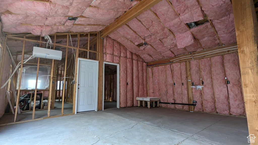 Misc room with concrete floors and vaulted ceiling